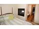Main bedroom with king-size bed and ensuite bathroom at 31730 Clay Gully Rd, Myakka City, FL 34251