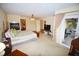 Main bedroom with king bed, fireplace, and access to porch at 31730 Clay Gully Rd, Myakka City, FL 34251