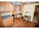 Home office with built-in cabinets and wood flooring at 31730 Clay Gully Rd, Myakka City, FL 34251