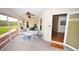 Relaxing screened porch with table and chairs, offering view of backyard at 31730 Clay Gully Rd, Myakka City, FL 34251