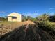 View of the property's grassy yard and barn at 31730 Clay Gully Rd, Myakka City, FL 34251