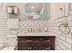 Bathroom with white subway tile, marble vanity, and a bathtub at 321 Hills Rd, Nokomis, FL 34275