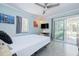 Main bedroom with light blue walls and access to a private patio at 321 Hills Rd, Nokomis, FL 34275