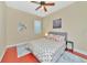 Spacious bedroom with a queen bed, ceiling fan, and window with blinds at 3970 Serenity Cir, Sarasota, FL 34235