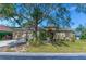 One-story house with a large tree in front and a paved walkway at 3970 Serenity Cir, Sarasota, FL 34235