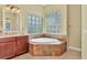 Relaxing bathroom with corner soaking tub and updated vanity at 3970 Serenity Cir, Sarasota, FL 34235