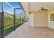 Spacious screened patio with tiled floor and ceiling fan at 3970 Serenity Cir, Sarasota, FL 34235