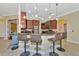 Kitchen boasts a breakfast bar, stainless steel appliances, and dark wood cabinets at 3970 Serenity Cir, Sarasota, FL 34235