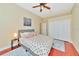 Bright bedroom with a queen bed, ceiling fan, and double-door closet at 3970 Serenity Cir, Sarasota, FL 34235