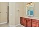 Bathroom features a vanity with wood cabinets and a large mirror at 3970 Serenity Cir, Sarasota, FL 34235