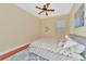 Well-lit bedroom with queen bed, ceiling fan, and wood flooring at 3970 Serenity Cir, Sarasota, FL 34235