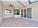 Covered patio with tiled flooring, access to the living room, and a ceiling fan at 3970 Serenity Cir, Sarasota, FL 34235