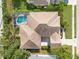 Aerial view of the house featuring a screen enclosed pool and lush, mature landscaping at 403 Bow Ln, Bradenton, FL 34208