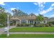 Tan house with mature landscaping, a driveway, and a mailbox at 403 Bow Ln, Bradenton, FL 34208