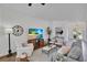 Comfortable living room with neutral decor, beach view on the TV, and plant adds life to the interior at 403 Bow Ln, Bradenton, FL 34208