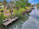 Aerial view of waterfront property with private dock and boat slips at 444 Bellini Cir, Nokomis, FL 34275