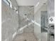 Modern bathroom with a walk-in shower, tile walls, and ample natural light at 5058 Surfside Cir, Lakewood Ranch, FL 34211