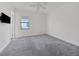 Bright bedroom with grey carpet, ceiling fan, and window at 5058 Surfside Cir, Lakewood Ranch, FL 34211