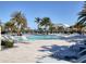 Expansive community pool with surrounding lounge chairs and palm trees at 5058 Surfside Cir, Lakewood Ranch, FL 34211