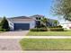 Beautiful single Gathering home featuring a three car garage and mature landscaping at 5058 Surfside Cir, Lakewood Ranch, FL 34211