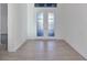 Bright foyer featuring tile flooring and decorative double doors with glass inserts at 5058 Surfside Cir, Lakewood Ranch, FL 34211