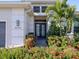 Elegant home entrance featuring a beautifully landscaped walkway and decorative double doors at 5058 Surfside Cir, Lakewood Ranch, FL 34211