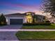 Stunning curb appeal of this single-Gathering home at dusk at 5058 Surfside Cir, Lakewood Ranch, FL 34211