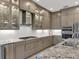 Modern kitchen featuring stainless steel appliances, granite counters, and custom cabinetry at 5058 Surfside Cir, Lakewood Ranch, FL 34211