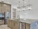Kitchen island with stainless steel appliances, granite countertop, and modern pendant lighting at 5058 Surfside Cir, Lakewood Ranch, FL 34211