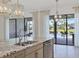 Kitchen with an island, view of the pool, and modern light fixtures at 5058 Surfside Cir, Lakewood Ranch, FL 34211