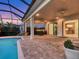 Outdoor kitchen and pool area with seating and a view into the home at 5058 Surfside Cir, Lakewood Ranch, FL 34211