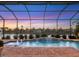 Stunning pool and spa with fire pit at sunset at 5058 Surfside Cir, Lakewood Ranch, FL 34211