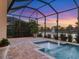 Enjoy sunset views from your screened lanai overlooking a relaxing pool with water features at 5058 Surfside Cir, Lakewood Ranch, FL 34211