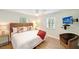 King bedroom with wood floors and a wall-mounted TV at 5610 Avenida Del Mare, Sarasota, FL 34242