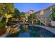 Inviting swimming pool surrounded by tropical landscaping at 5610 Avenida Del Mare, Sarasota, FL 34242