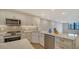 Open concept kitchen with stainless steel appliances and island at 5760 Midnight Pass Rd # 307D, Sarasota, FL 34242