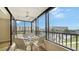 Screened-in balcony features a table and seating with a scenic waterfront view at 5760 Midnight Pass Rd # 307D, Sarasota, FL 34242