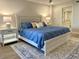 Stylish bedroom with tile flooring, an area rug, and ensuite bathroom access at 5760 Midnight Pass Rd # 307D, Sarasota, FL 34242