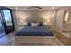 Bright bedroom with a plush blue comforter, white furniture, and access to the balcony at 5760 Midnight Pass Rd # 307D, Sarasota, FL 34242