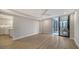 Open concept living room with kitchen view and balcony access at 5760 Midnight Pass Rd # 307D, Sarasota, FL 34242