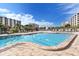 Resort-style pool with plenty of lounge chairs and umbrellas at 5760 Midnight Pass Rd # 307D, Sarasota, FL 34242