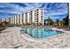 Attractive rectangular pool with surrounding lounge chairs and patio at 5760 Midnight Pass Rd # 307D, Sarasota, FL 34242