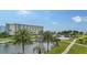 Beautiful waterfront view with a resort-style pool and lush landscaping at 5760 Midnight Pass Rd # 307D, Sarasota, FL 34242