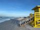 Beachfront property with a yellow lifeguard stand at 5760 Midnight Pass Rd # 307D, Sarasota, FL 34242