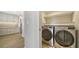 Convenient laundry room with LG washer and dryer, and cabinets at 5760 Midnight Pass Rd # 307D, Sarasota, FL 34242