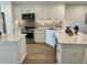 Updated kitchen features white cabinetry, stainless steel appliances, and stylish backsplash at 5760 Midnight Pass Rd # 307D, Sarasota, FL 34242
