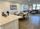 Open-concept layout with kitchen island, dining area, and living room filled with stylish decor at 5760 Midnight Pass Rd # 307D, Sarasota, FL 34242