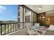 Spacious balcony with table and chairs, offering scenic views at 5760 Midnight Pass Rd # 307D, Sarasota, FL 34242