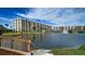 Community features a tranquil pond, lush landscaping, and multiple buildings at 5760 Midnight Pass Rd # 307D, Sarasota, FL 34242
