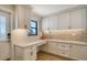 Bright laundry room with white cabinets and quartz countertop at 5760 Midnight Pass Rd # 307D, Sarasota, FL 34242